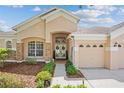 Charming home featuring a manicured lawn, stone accents, mature shrubs and a welcoming entryway at 4608 Kilcoyne Ct, Lutz, FL 33558