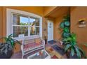 Cozy front porch with comfortable seating and decorative plants creating a welcoming entrance at 4961 Marble Springs Cir, Wimauma, FL 33598