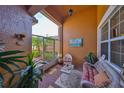 Relaxing screened porch featuring comfortable seating and a view of the landscaped outdoors at 4961 Marble Springs Cir, Wimauma, FL 33598