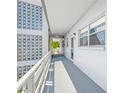 Exterior hallway with decorative breeze blocks leading to resident entrance at 5660 80Th N St # D207, St Petersburg, FL 33709