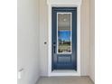 Elegant front door with glass, set in a pristine, light-colored wall at 5979 Hidden Branch Dr, Apollo Beach, FL 33572