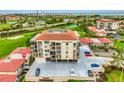 Exterior view of condo building showing parking, landscaping and proximity to golf course at 6269 Palma Del Mar S Blvd # 206, St Petersburg, FL 33715