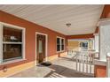 Inviting front porch with a wooden door, stucco walls, and a concrete floor at 6414 N Central Ave, Tampa, FL 33604