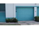 Attached garage with a light blue door and a partial view of the unit's entrance at 6618 Pineview Ter # 6618, Bradenton, FL 34203