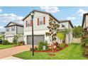 This home features a lush lawn and well-maintained landscaping, enhancing its curb appeal at 10815 Windswept Garden Way, Tampa, FL 33647