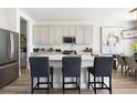 Modern kitchen features stainless steel appliances, a large island with seating, and ample cabinet space at 12164 Cattleside Dr, Riverview, FL 33579