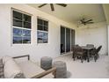 Relaxing covered patio with comfortable seating and a ceiling fan, perfect for enjoying the outdoor space at 12166 Cattleside Dr, Riverview, FL 33579