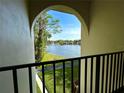 Charming view from the balcony overlooking a scenic lake and fountain at 1423 Pine Glen Ln # D2, Tarpon Springs, FL 34688