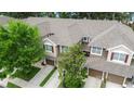 Aerial view of townhomes with well-maintained roofs and surrounding mature trees at 2009 River Turia Cir, Riverview, FL 33578