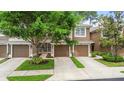 Charming two-story townhome with a well-manicured lawn and attached garage at 2009 River Turia Cir, Riverview, FL 33578