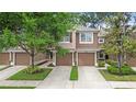 Two-story townhome featuring attached garages and well-manicured landscaping at 2009 River Turia Cir, Riverview, FL 33578