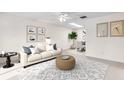 Bright living room with a neutral palette, comfortable seating, and ample natural light from skylights and large windows at 2241 Shelly Dr # D, Palm Harbor, FL 34684
