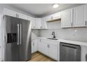Modern kitchen with stainless steel appliances, white cabinets, and sleek countertops perfect for cooking and entertaining at 2801 Poinciana Ct, Punta Gorda, FL 33950