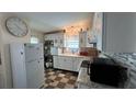 Bright and functional kitchen with ample counter space, white cabinets, and modern appliances for meal preparation at 3829 Chah Dr, Zephyrhills, FL 33541