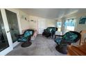 Comfortable sunroom with ample seating and natural light, perfect for relaxation and entertaining guests at 3829 Chah Dr, Zephyrhills, FL 33541