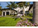 Charming entry to the property showcasing an elegant entrance and beautifully landscaped front yard with colorful flowers at 389 Bayview Ne Dr, St Petersburg, FL 33704