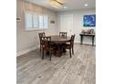 Cozy dining room featuring new hardwood flooring, a modern light fixture, and a wet bar at 428 45Th N Ave, St Petersburg, FL 33703