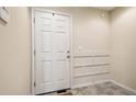 Bright foyer with neutral-toned walls, tiled floors, and classic white paneled door at 5022 Chipotle Ln, Wesley Chapel, FL 33544