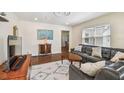 Cozy living room featuring hardwood floors, a comfortable leather sofa, and ample natural light from the window at 503 N Macdill Ave, Tampa, FL 33609
