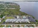 Beautiful aerial view of a bayfront property with a community pool, tennis court and boat dock at 515 Leffingwell Ave # 211, Ellenton, FL 34222