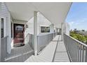 Inviting balcony view with metal railings, covered walkway and a peek of the outdoors at 515 Leffingwell Ave # 211, Ellenton, FL 34222
