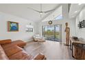 Bright living room with vaulted ceilings, modern decor, and a view of the balcony at 515 Leffingwell Ave # 211, Ellenton, FL 34222