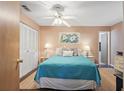 Comfortable bedroom with a queen bed, matching nightstands, and a ceiling fan at 5246 81 N St # 24, St Petersburg, FL 33709