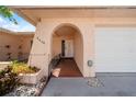 Inviting entryway with an arched doorway and tiled walkway leading to the front door at 5428 Larchmont N Ct # 5428, Pinellas Park, FL 33782
