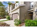 Side exterior showcasing a townhome with a landscaped yard at 5619 Tranquil Pond Pl, Riverview, FL 33578