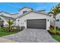 Spacious two car garage and paved driveway with manicured landscaping along the perimeter at 6023 Cat Claw Ln, Bradenton, FL 34210