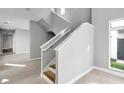 Modern staircase with a neutral color palette and plenty of natural light at 6023 Cat Claw Ln, Bradenton, FL 34210
