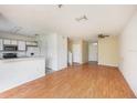 Open-concept living and kitchen area features laminate floors at 6236 Olivedale Dr, Riverview, FL 33578