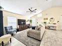 Inviting living room featuring a large window and neutral-toned decor at 6248 Tabogi Trl, Wesley Chapel, FL 33545