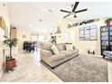 Open-concept living room with tile floors and modern furnishings at 6248 Tabogi Trl, Wesley Chapel, FL 33545