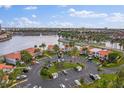 Beautiful aerial view of condos with a parking area surrounded by lush landscaping and a serene lake at 6277 Bahia Del Mar Blvd # 110, St Petersburg, FL 33715