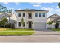 Stunning two-story home featuring a two-car garage, landscaped yard, and modern architectural design at 803 W Woodlawn Ave, Tampa, FL 33603