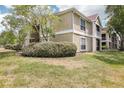 Well-manicured lawn and facade on this condo featuring beautiful landscaping and natural light at 9481 Highland Oak Dr # 1616, Tampa, FL 33647