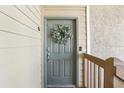 Charming front door adorned with a wreath, offering a warm welcome to this lovely condo at 9481 Highland Oak Dr # 1616, Tampa, FL 33647