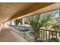 Exterior balcony view with railing overlooking a well-manicured lawn and landscaping offering a serene outdoor retreat at 10035 63Rd N Ave # 23, St Petersburg, FL 33708