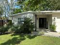 Charming single-story home with beautifully landscaped front yard and inviting entryway at 10074 Bahama Ct, Seminole, FL 33776