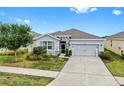 Charming single-story home with a well-manicured lawn and a two car garage during the day at 13749 Hunting Creek Pl, Spring Hill, FL 34609