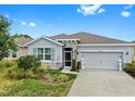 Charming single-story home with a well-manicured lawn and a two car garage during the day at 13749 Hunting Creek Pl, Spring Hill, FL 34609