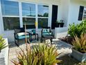Welcoming front porch with seating area, aloe plants, and great light at 14019 89Th Ave, Seminole, FL 33776