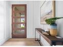 Elegant entryway featuring a stylish front door with glass panes and a modern console table at 187 145Th E Ave # 4, St Petersburg, FL 33708