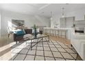 Bright open-concept living space with modern furnishings and a view of the kitchen island at 187 145Th E Ave # 4, St Petersburg, FL 33708