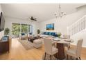 Bright living room featuring a dining area, comfortable seating, and a sliding glass door to the outdoors at 26517 Castleview Way, Wesley Chapel, FL 33544