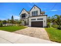 Beautiful two-story home features modern design, brick accents, a paved driveway, and a well-kept lawn at 3020 W Helen Ave, Tampa, FL 33611
