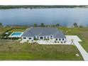 Aerial view of an estate featuring a refreshing backyard pool and stunning lake views, perfect for luxury living at 3409 Gulf City Rd, Ruskin, FL 33570