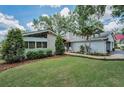 Well-kept single-story home showing off its landscaping, stone accents, and a walkway to the front entrance at 3603 Schefflera Rd, Tampa, FL 33618