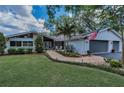 Attractive single-story home boasting well-maintained landscaping, a brick walkway, and a two-car garage at 3603 Schefflera Rd, Tampa, FL 33618